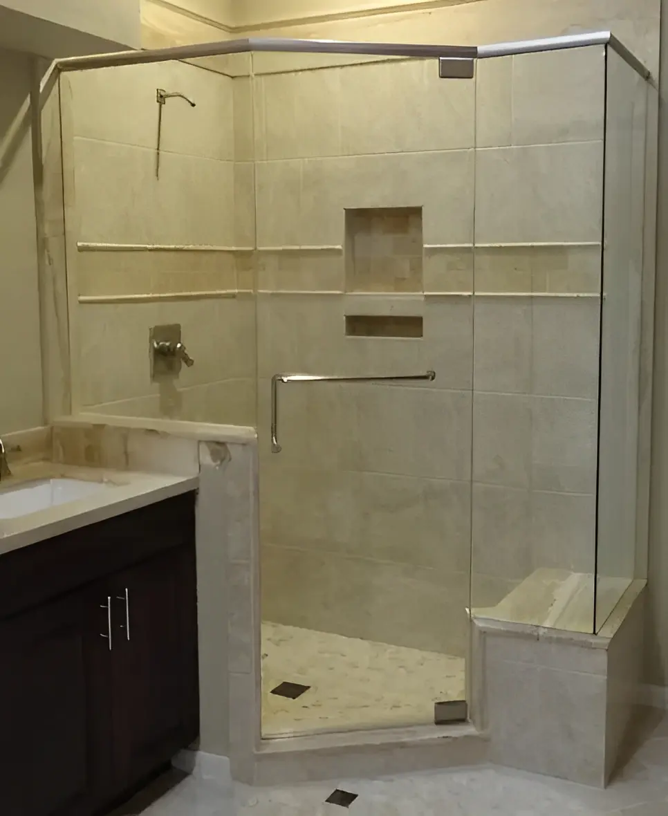 Modern glass shower enclosure with tiled walls.